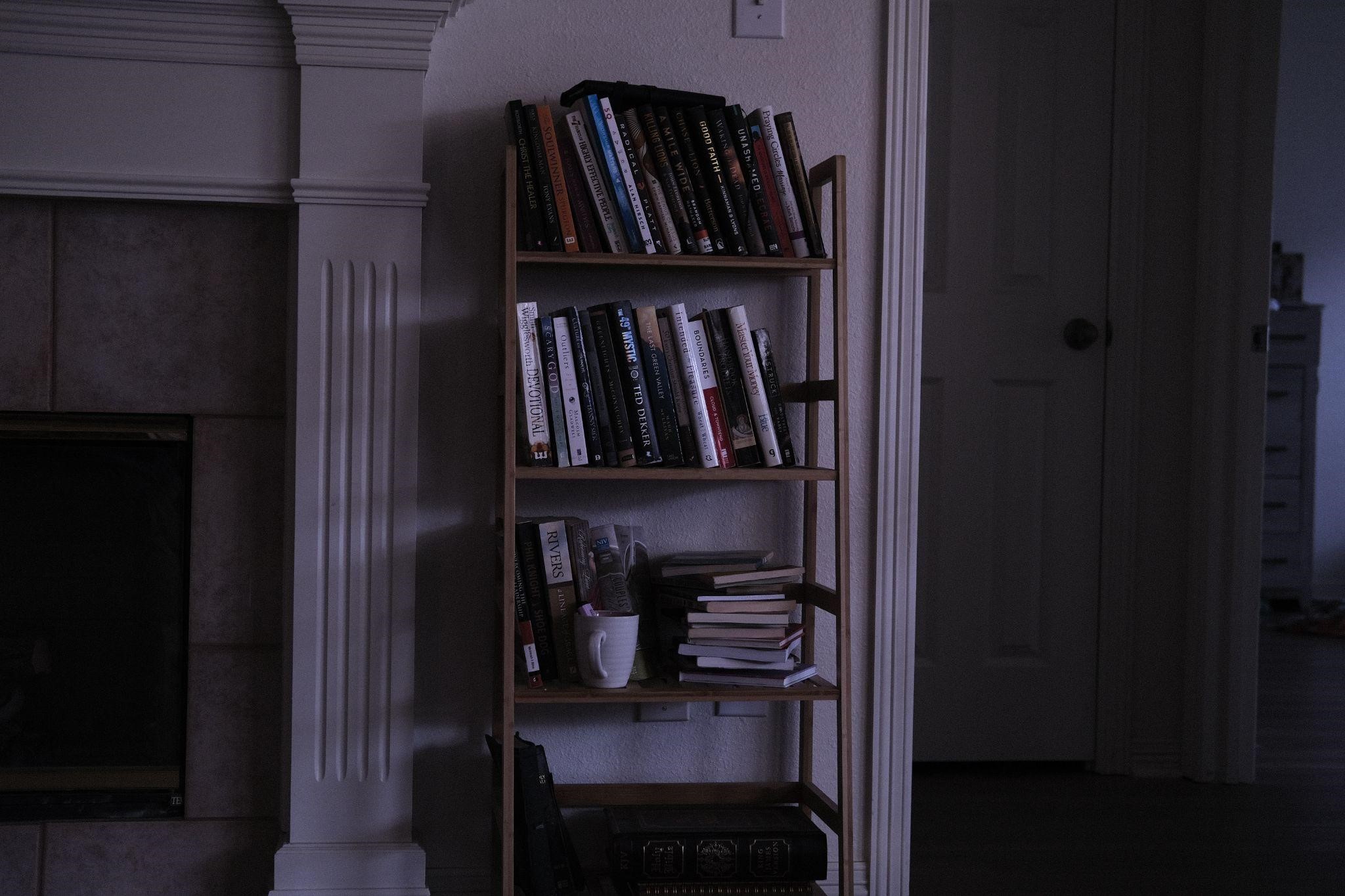 Books on the shelf, mirroring an eerie vibe that represents how novels portray money laundering in crime thrillers.