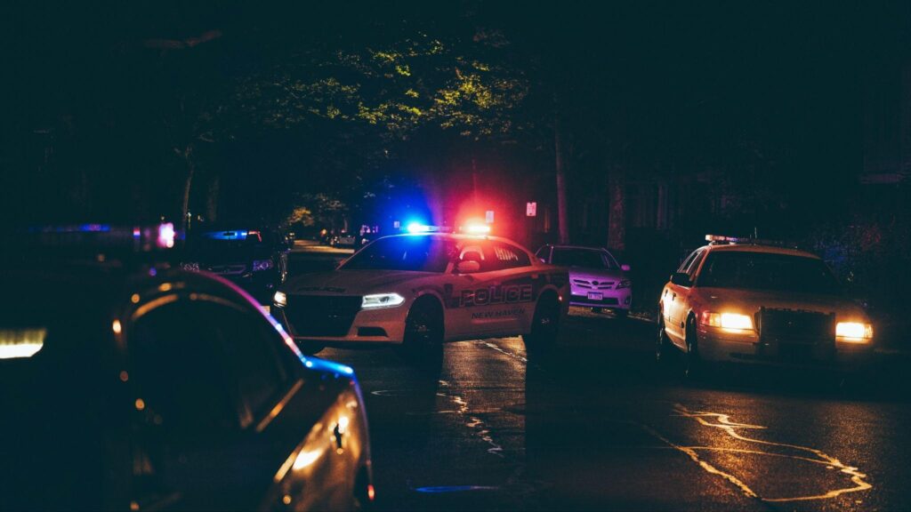 Police cars parked in a crime scene, emitting a thrilling atmosphere.