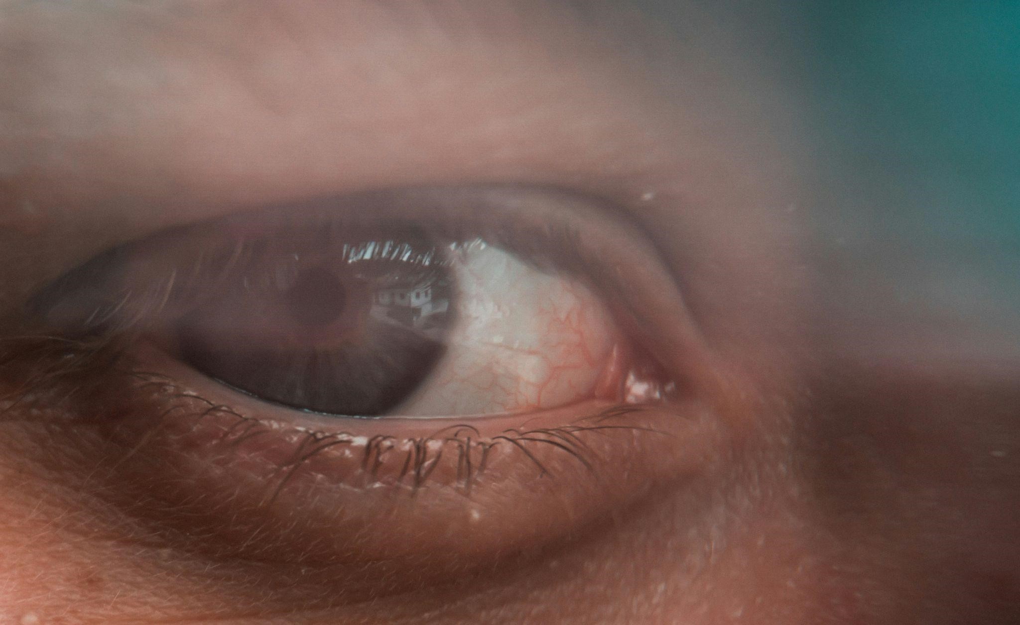 davidstewartmonth3gw2 Close-up of a human eye, slightly unfocused, symbolizing tales of the witness relocation program.